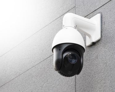 Modern public CCTV cameras on white wall. Intelligent reccording cameras for monitoring all day and night. Concept of surveillance and monitoring with copy space and clipping path.